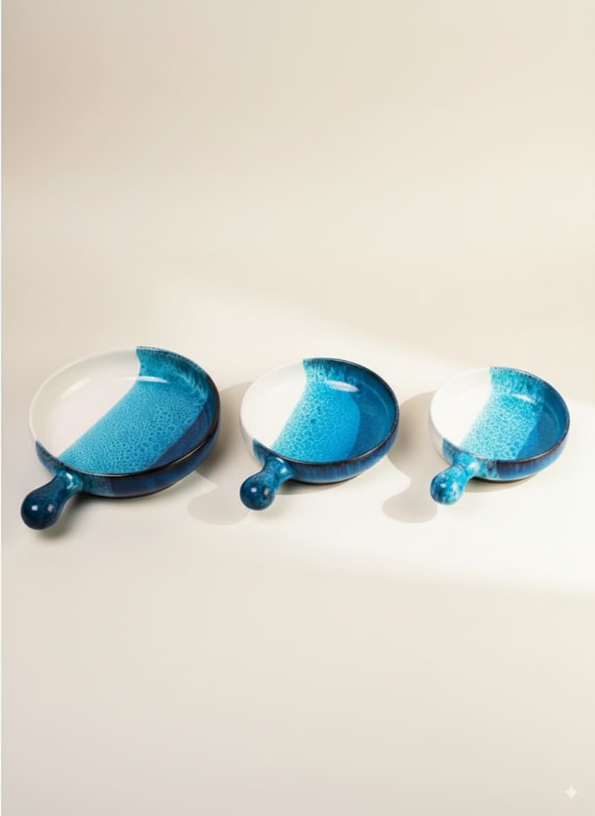 Set of three handmade pottery serving pans with handles in a stunning ocean blue reactive glaze.