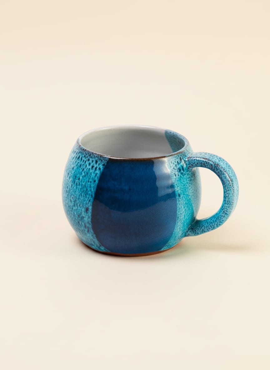 Handcrafted ocean blue stoneware mug with a unique reactive glaze finish.