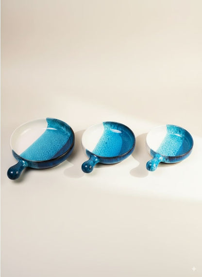 Set of three handmade pottery serving pans with handles in a stunning ocean blue reactive glaze.