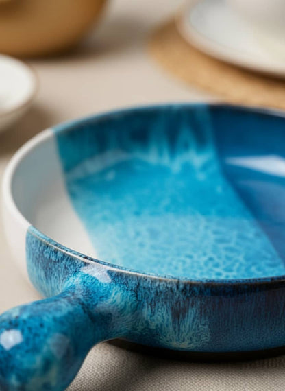 Close-up of the durable fired clay and unique reactive glaze finish on a blue ceramic serving pan.