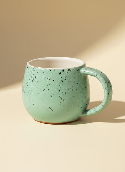 Mint green speckled ceramic pottery mug with a comfortable rounded handle.