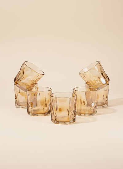 Set of six amber twisted glass tea cups with a unique swirl texture, arranged on a white background.