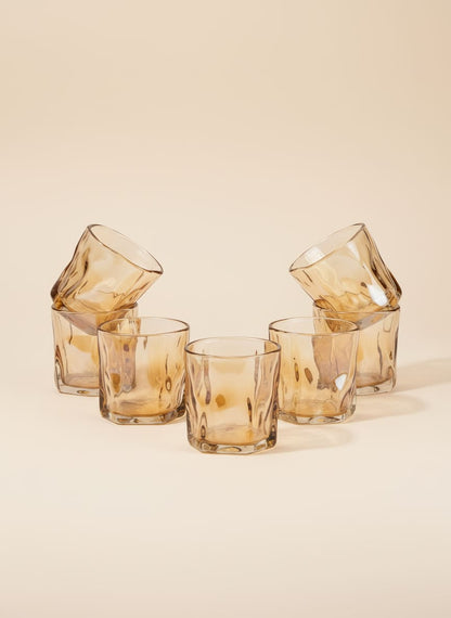 Set of six amber twisted glass tea cups with a unique swirl texture, arranged on a white background.