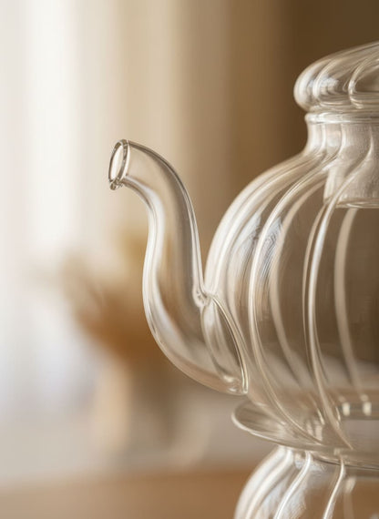 Close-up of the durable, heat-resistant borosilicate glass and smooth, drip-free spout of the CasaHome teapot.