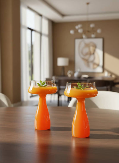 Stylish orange stem goblet perfect for serving Egyptian juices or desserts at a family gathering.