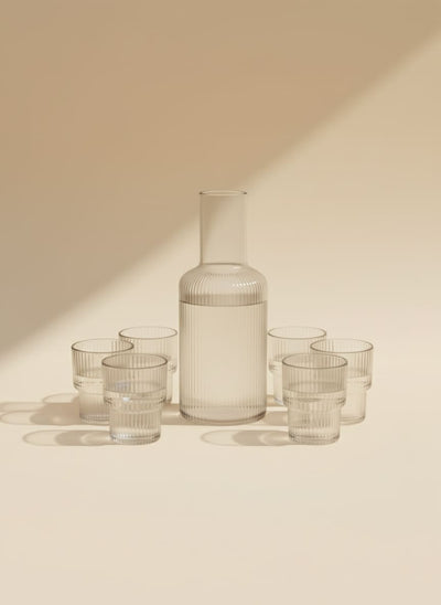 Elegant 7-piece ribbed glass carafe and tumbler set on a clean white background, perfect for serving drinks.
