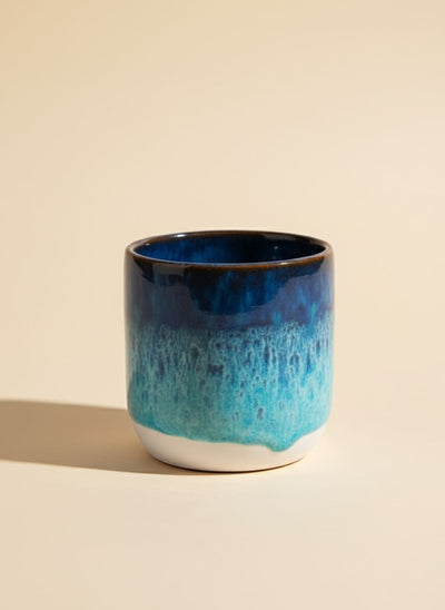 Ocean blue ceramic tumbler with a reactive glaze finish.
