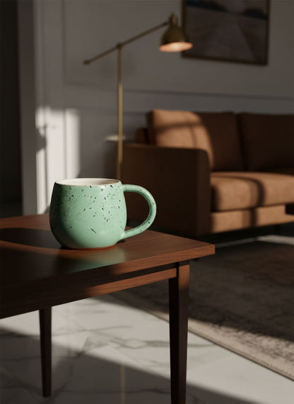 Artisan-crafted mint green mug with a sophisticated speckled glaze finish.