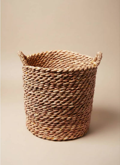 Natural woven rope storage basket with integrated handles for home organization.
