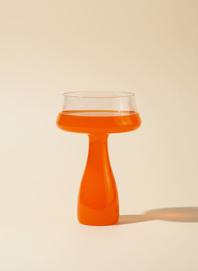 Modern 300ml glass goblet with a striking bright orange stem on a white background.