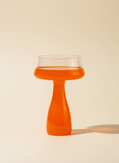 Modern 300ml glass goblet with a striking bright orange stem on a white background.