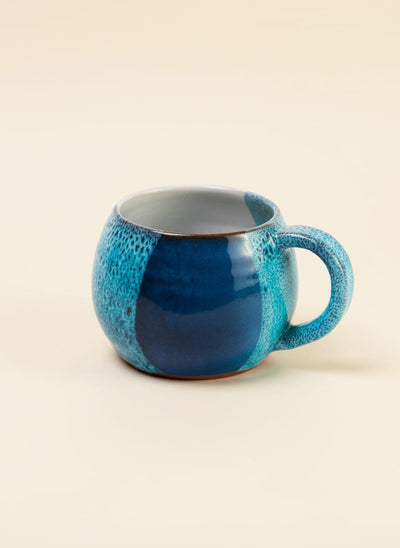 Handcrafted ocean blue stoneware mug with a unique reactive glaze finish.